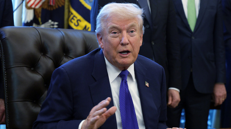 Donald Trump sitting at a chair