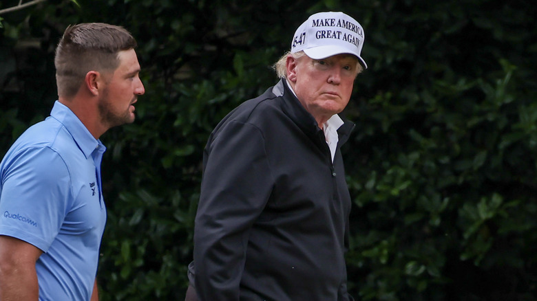 Donald Trump walking with Bryson DeChambeau