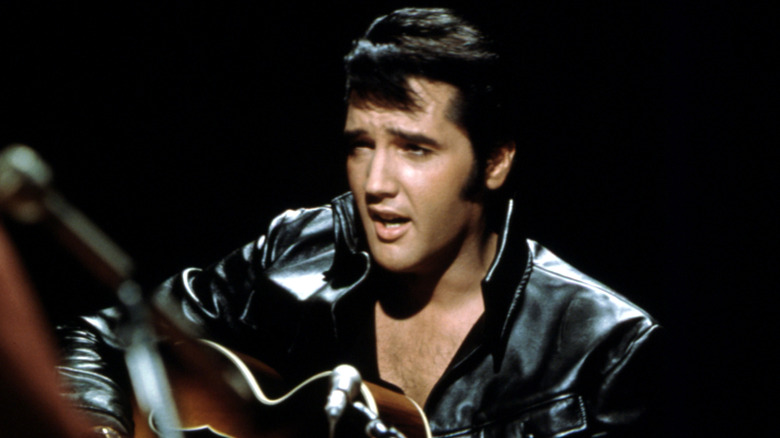 Elvis Presley singing and playing guitar