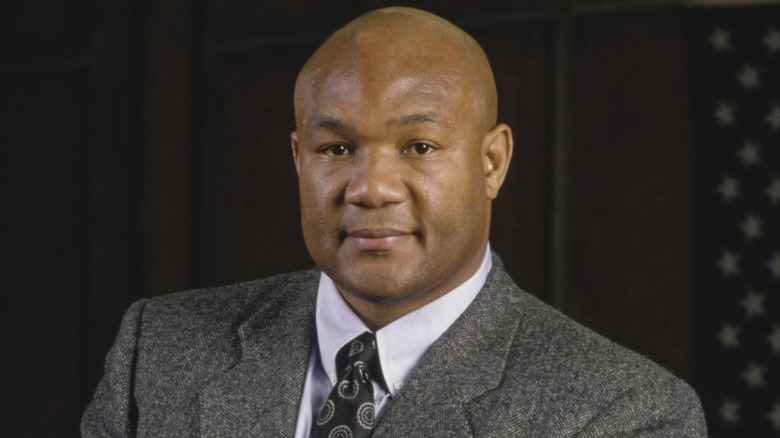George Foreman posing for cameras in gray wool suit