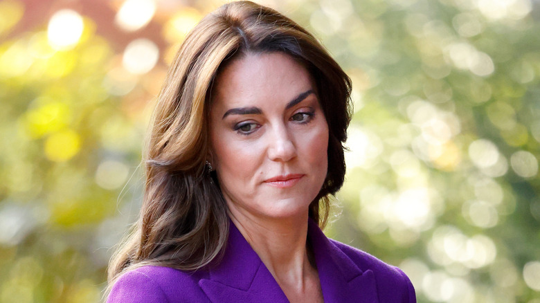 Kate Middleton with a serious expression and a blurred background