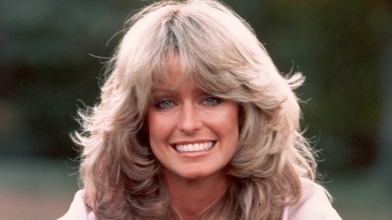 Farrah Fawcett smiling with her trademark feathered hair