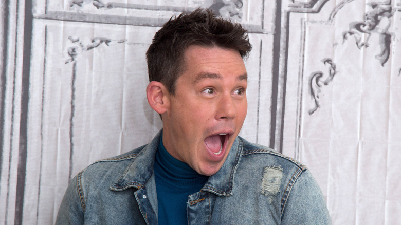 David Bromstad with a wide open mouth in front of a marble wall at AOL Studios In New York on February 3, 2016 in New York City.