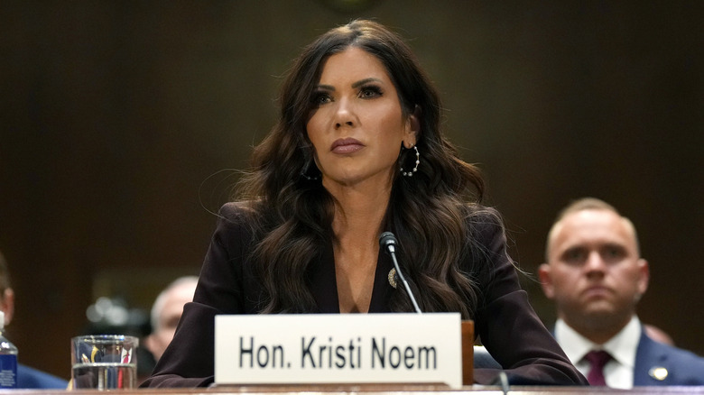 Kristi Noem sitting at a desk