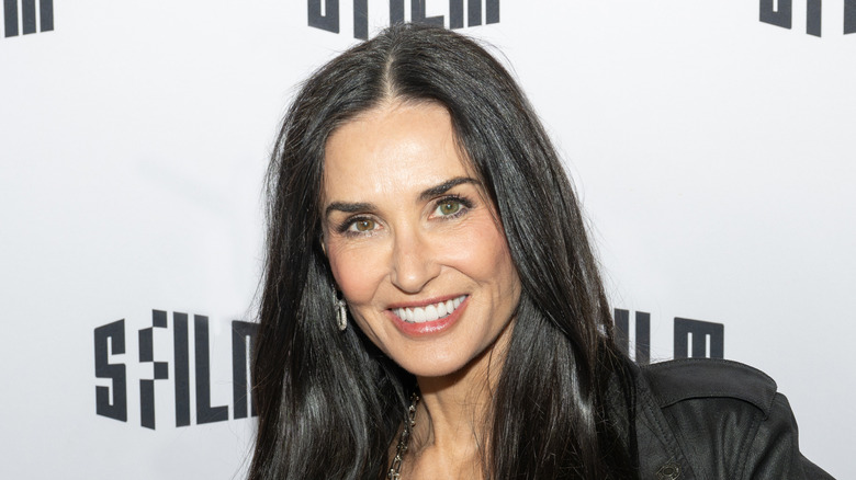 Demi Moore smiling while posing at an event in December 2024
