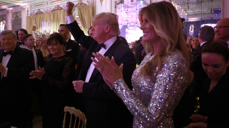 Melania Trump clapping alongside her husband at Mar-a-Lago.