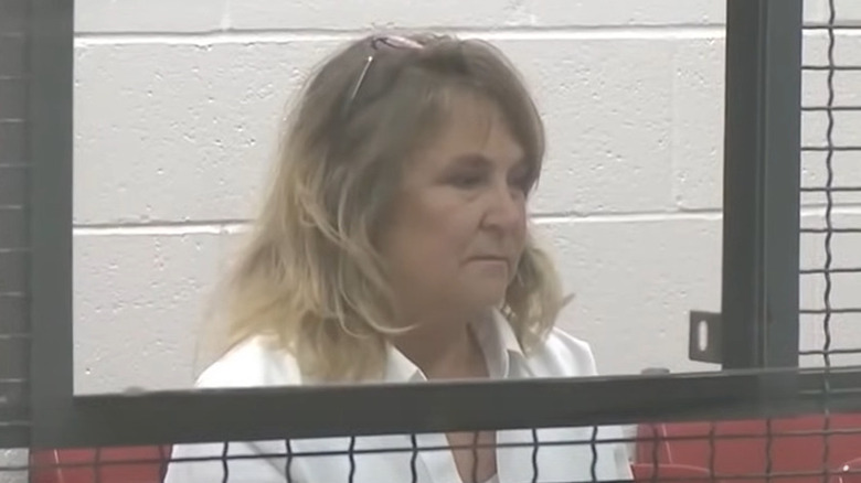 Becky Hill sitting behind bars in a courtroom