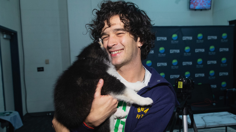 Matt Healy holding a puppy